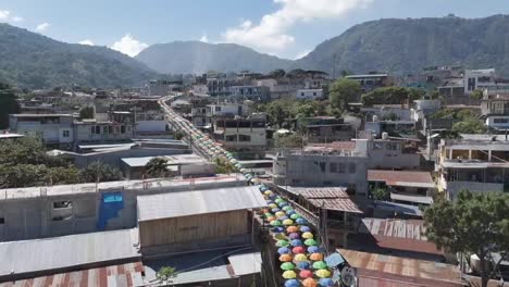 incredible landscape of the town of san juan la laguna surrounded by mountains with green vegetation and on the shore of lake atitlan, video about the famous umbrella street.