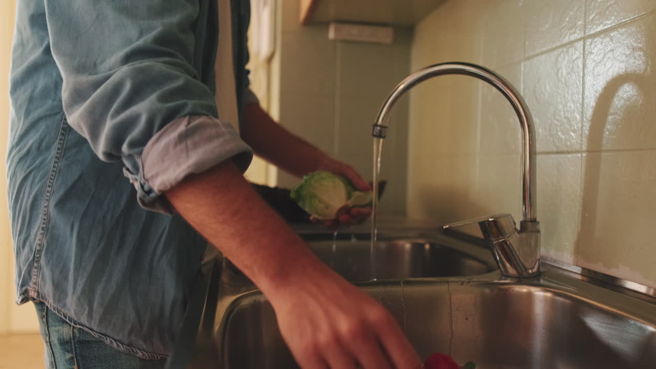 Washing vegetables in the kitchen sink