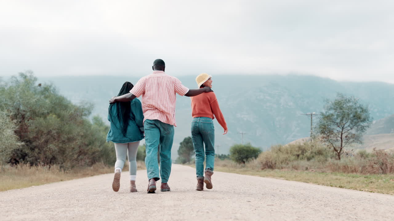 Friends walking down a road together