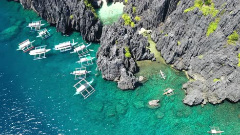 Secret Beach, El Nido, Palawan Island, Philippines. Aerial View of Double Outrigger Boats and Majestic Coast