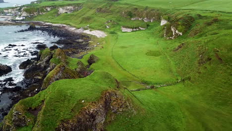 Revealing-drone-shot-of-coastline-in-Northern-Ireland-with-people