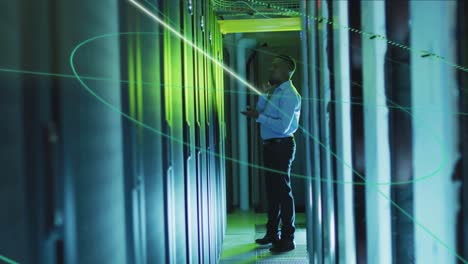 Animation-of-lines-over-african-american-man-working-in-server-room