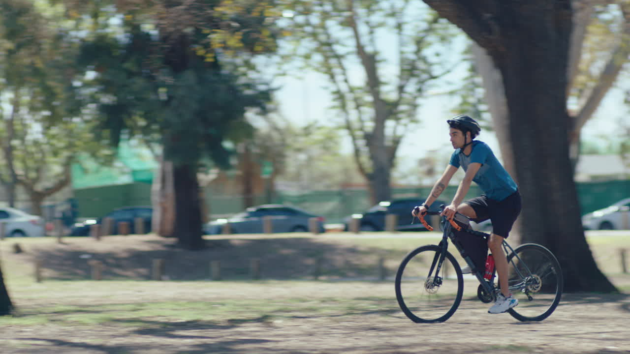 Man Riding Road Bike along Alley in the Park