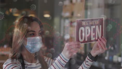 animation of coronavirus cells over caucasian female hairdresser closing salon wearing face mask