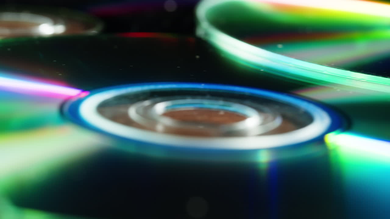 CD disks on black background close-up. Old vintage disks for DVD player or computer. Music recorder, playing retro computer games.