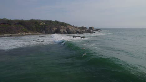 Vista-Aérea-De-Los-Surfistas-Tratando-De-Atrapar-La-Próxima-Gran-Ola-En-México