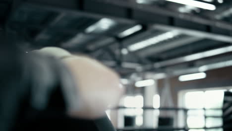 agitated fighter making hooks in fitness center