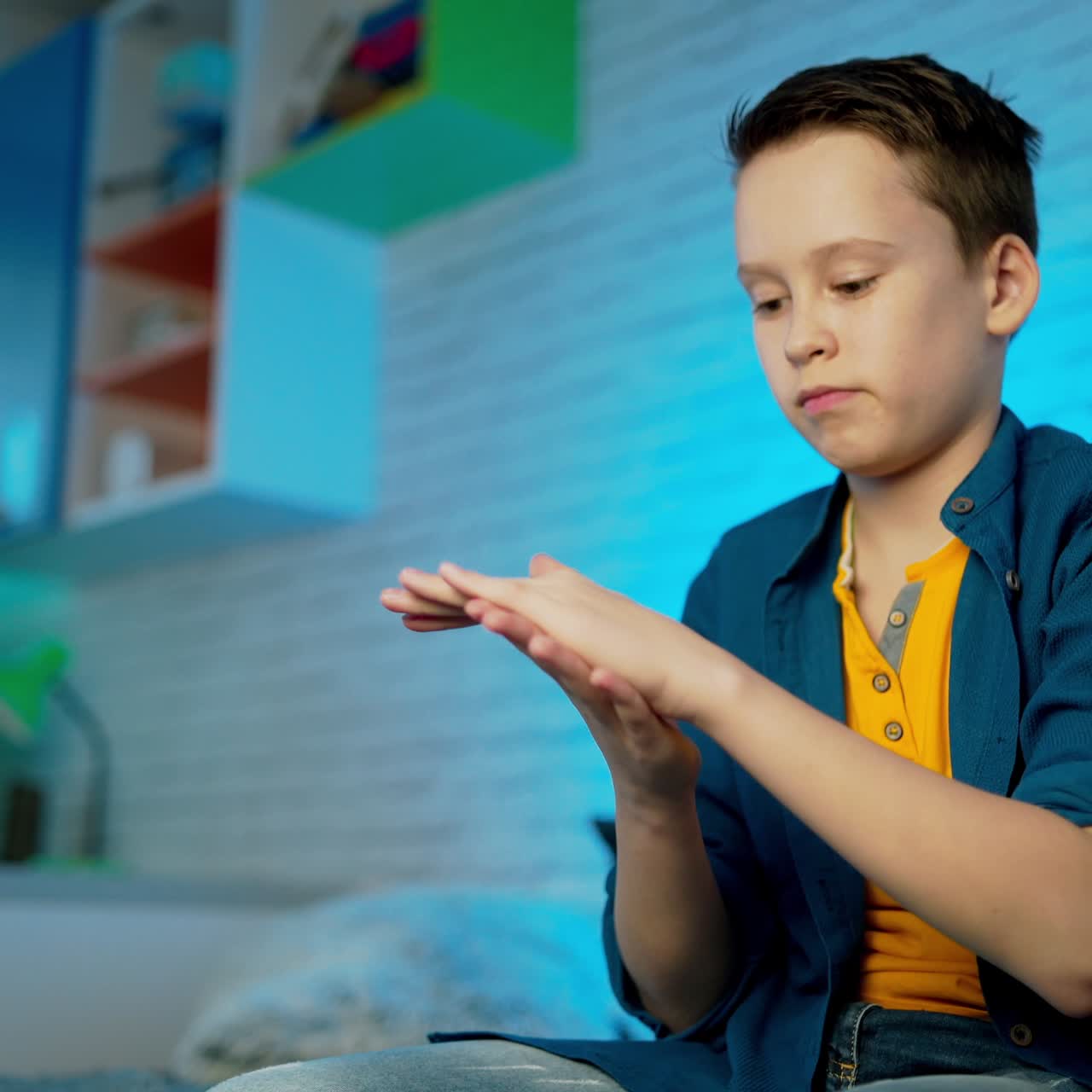 boy use disinfectant spray to protect his hand due to coronavirus epidemic. Hand disinfection. Disease prophylaxis.