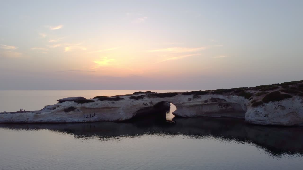 Oristano Coast Natural Arch of S'Archittu in Sardinia, peaceful sunset, aerial