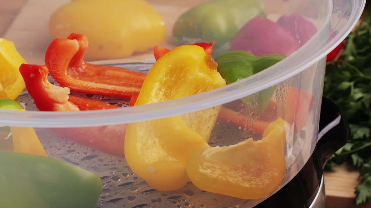 Mixed vegetables, carrots, broccoli, and cauliflower in a food double boiler steamer basket in a stainless steel pot, healthy diet cooking method preserving minerals, vitamins and flavor