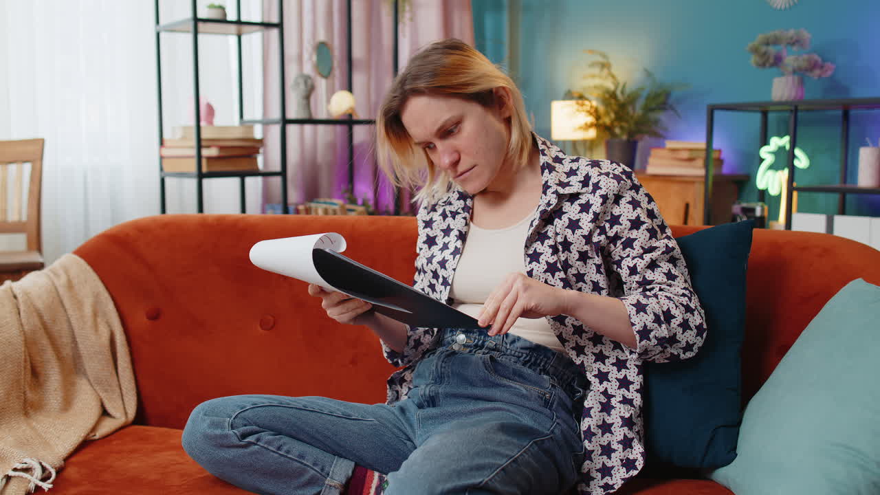 Woman freelancer work with documents from home, analyzing information read business financial report
