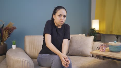 young woman looking at camera with cowardly eyes.