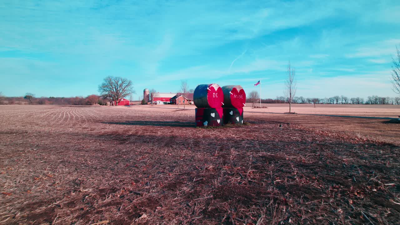 American farmers celebrating Valentine's Hay Bale Art in Countryside