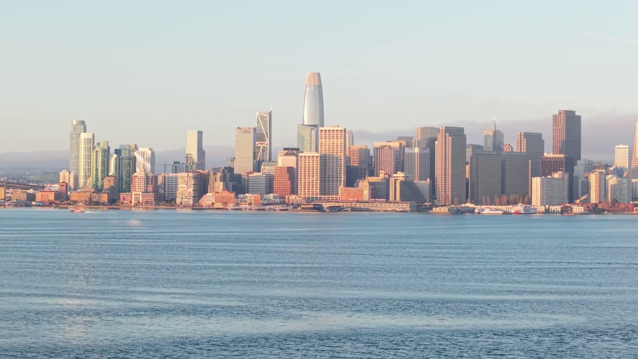 A left to right aerial panning shot of downtown San Francisco featuring the Bay Bridge.