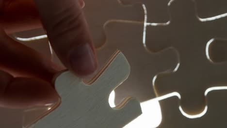 Animation-of-hand-of-caucasian-woman-playing-wooden-puzzle