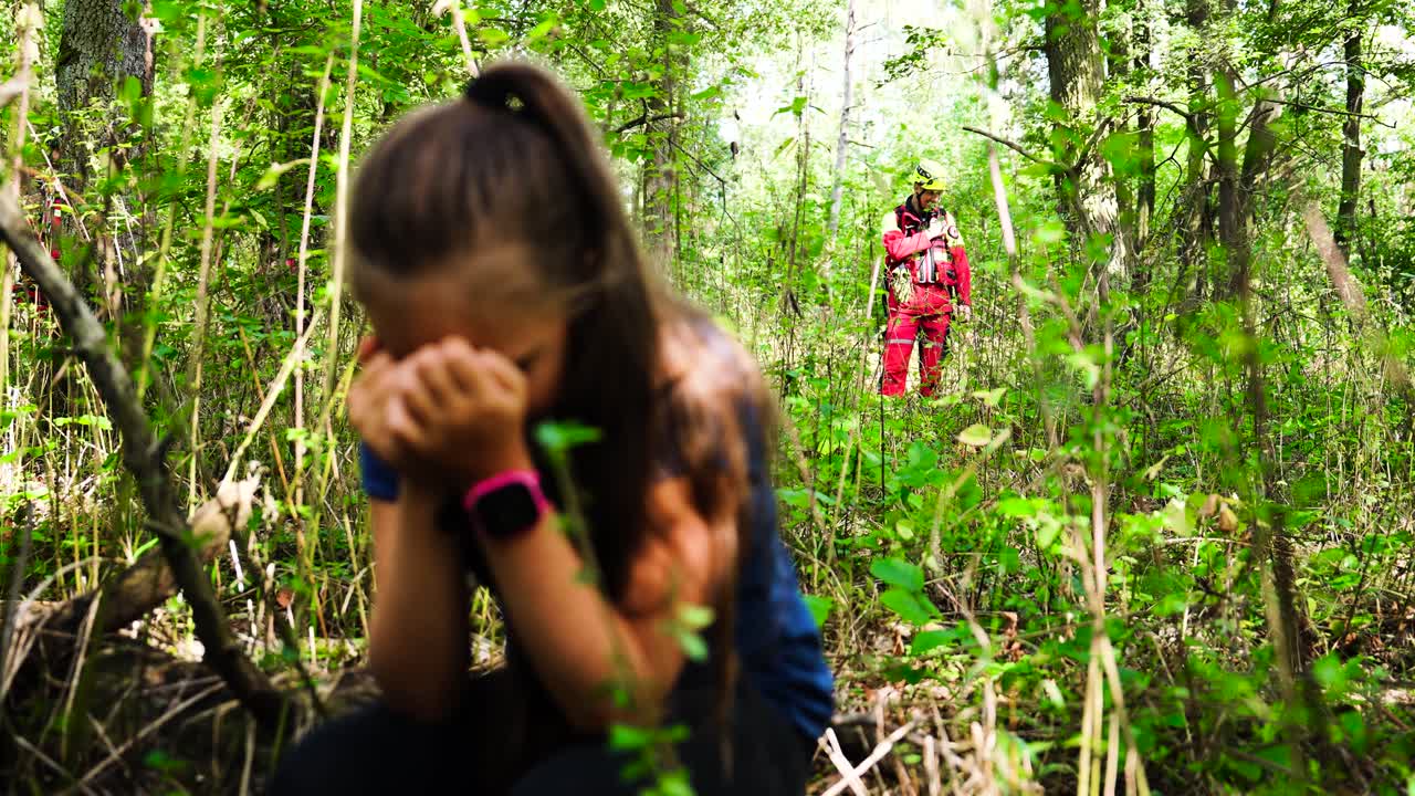 Girl Crying in Forest, Firefighter in Background