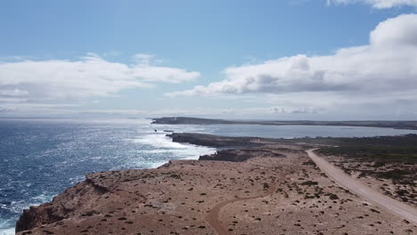 Empty-coastal-expanse-bordered-by-rugged-cliffs