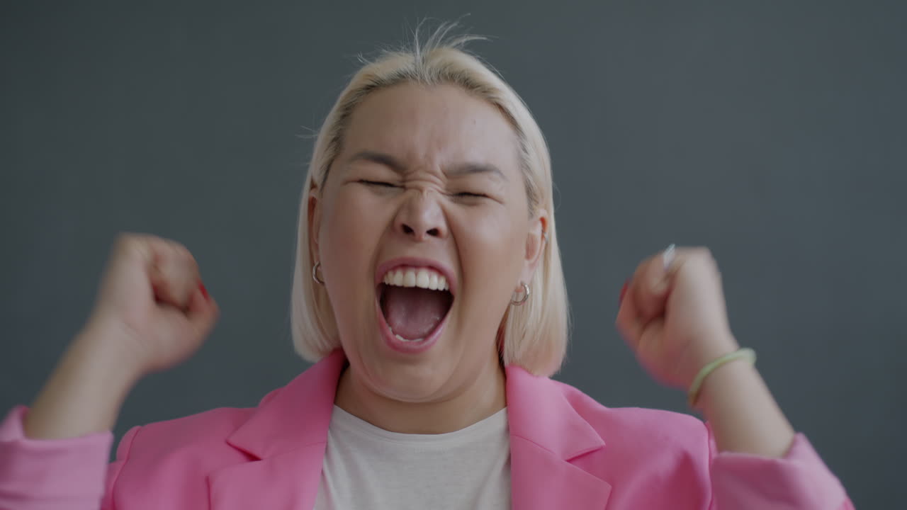 Excited Woman in Pink Blazer