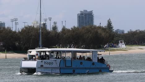 a ferry moves along a scenic waterfront