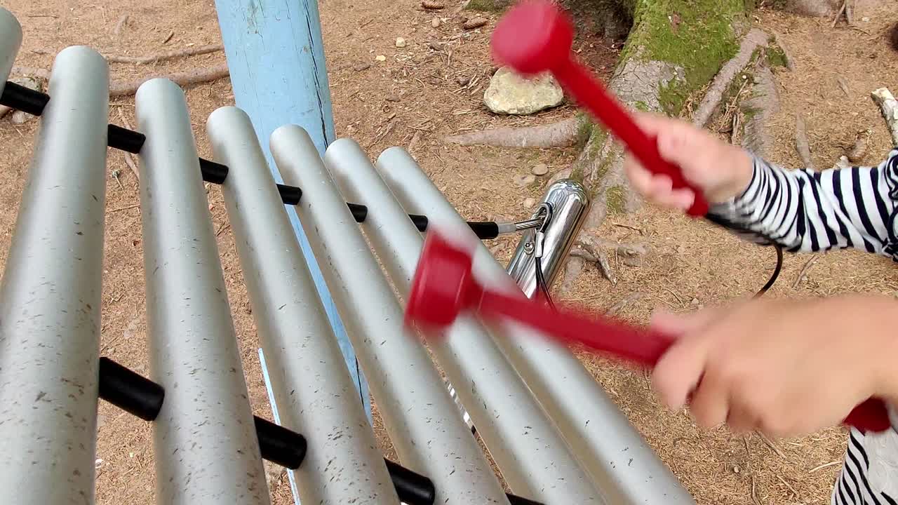 Musical connection outdoor xylophone percussion instrument played by a child