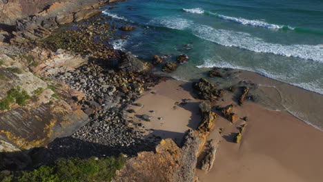 rugged australian new south wales rocky coastline at sunset, aerial arc shot