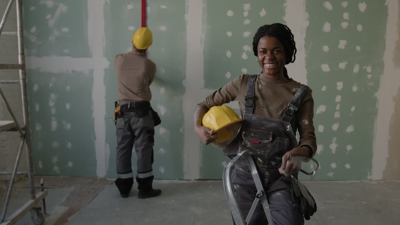 Construction workers renovating interior space