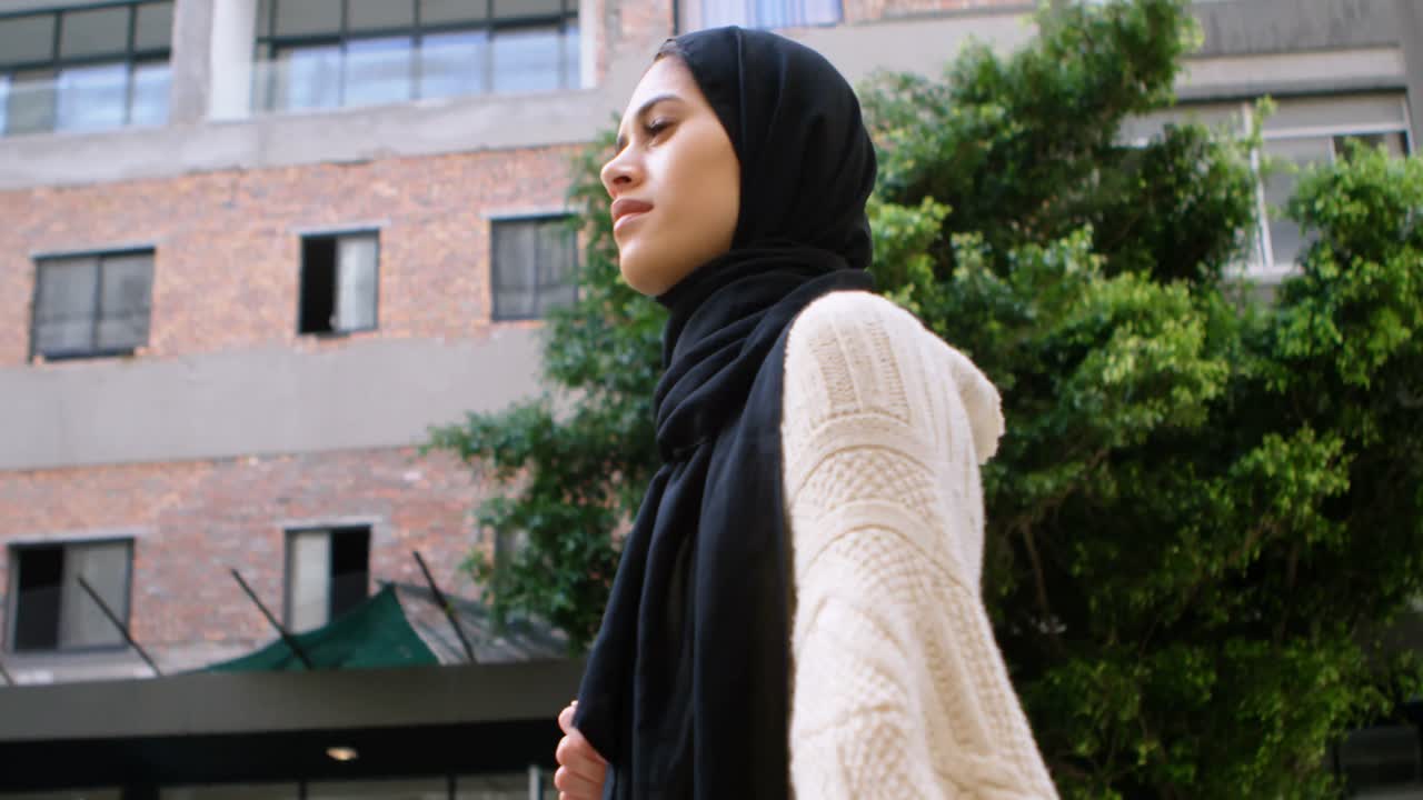 Woman in hijab walking in the city 4k