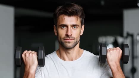 man lifting dumbbells in the gym