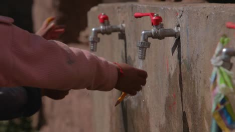 Peru-children-in-a-small-village-cleaning-their-paint-brushes-from-a-school-project