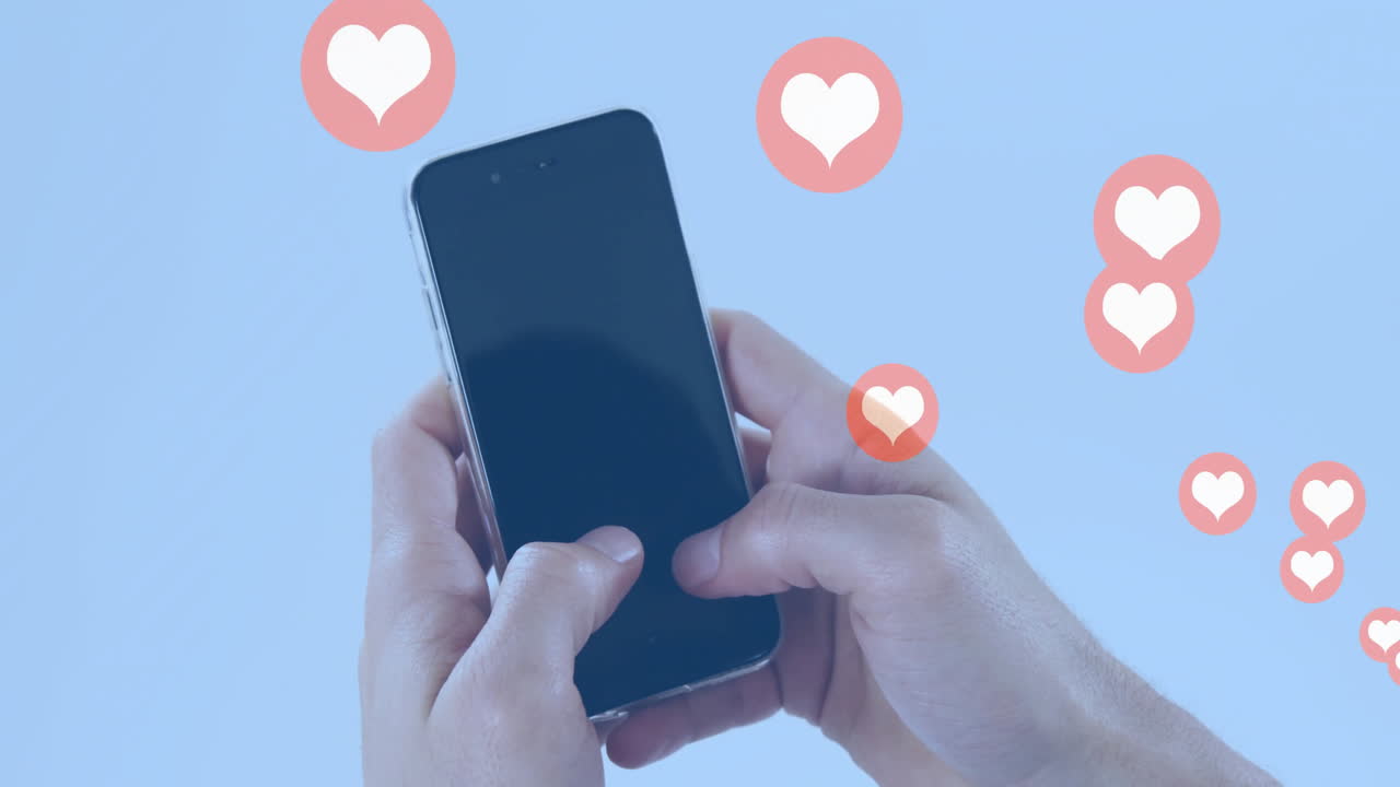 Holding smartphone with animation of floating heart icons on blue background