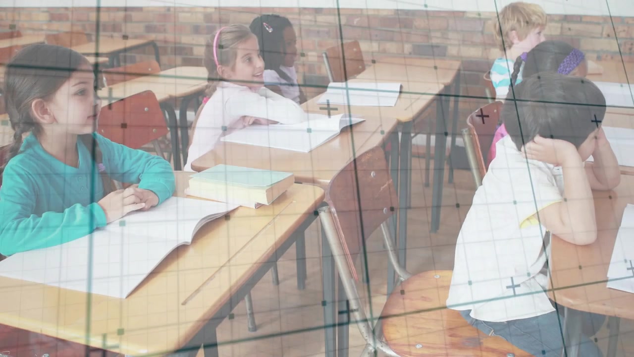 Diverse Elementary Students Sitting at Desks in Classroom