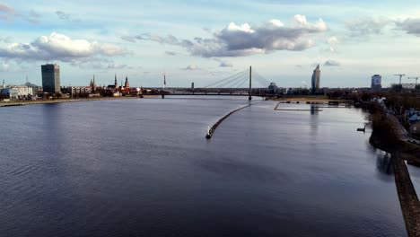 aerial view of daugava river with vansu bridge in the distance in riga, latvia