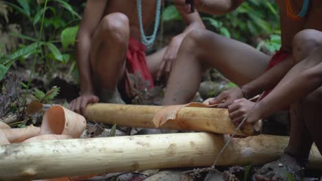 members of the mentawai tribe in indonesia make the material they use to create their loincloths