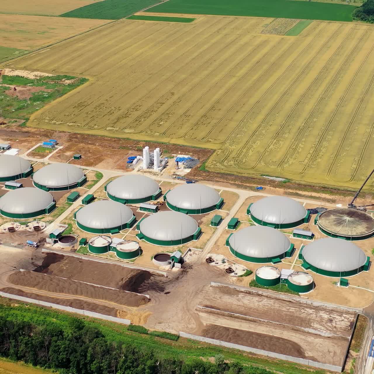 New agricultural plant for bio gas. Greenhouse complex is equipped with its own biogas for the production from biomass. Aerial view