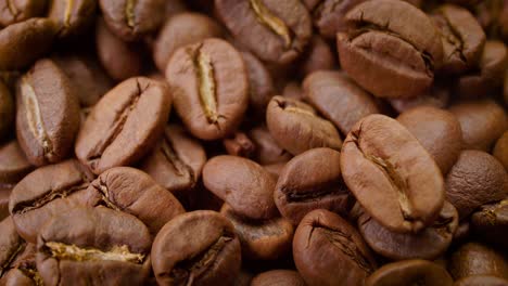 Close-up-of-seeds-of-coffee.-Fragrant-coffee-beans-are-roasted-smoke-comes-from-coffee-beans.