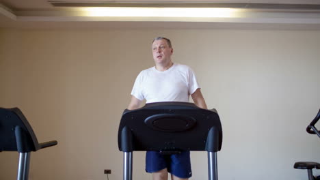 middle-aged man working out on a treadmill