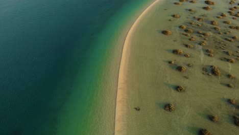 Sand-bank-splits-tropical-turquoise-deep-ocean-shallow-water-mangrove-shrubs