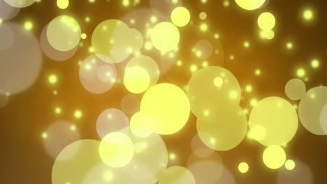 Glowing-yellow-bokeh-lights-animation-over-golden-background