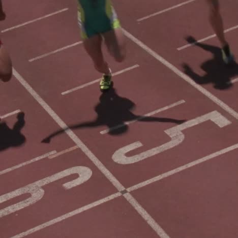 male racers reach the finish line one raises his arms