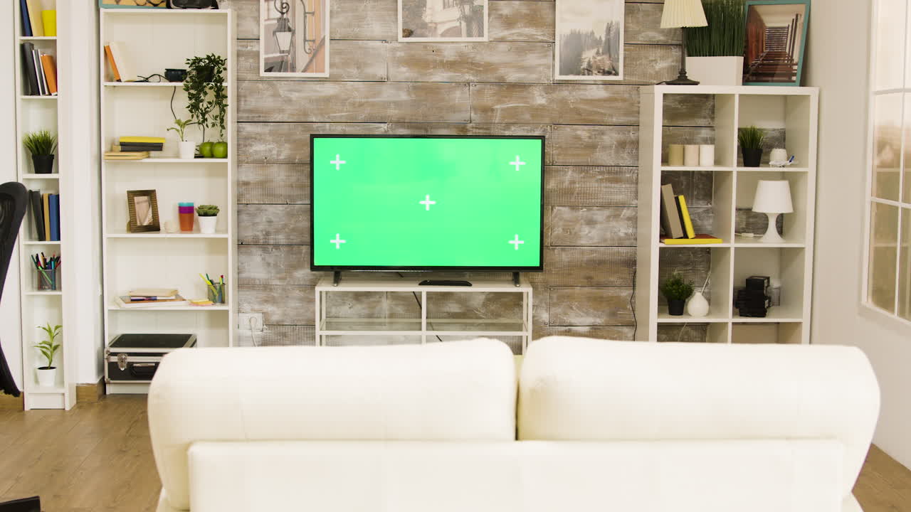 Living room interior with green screen television