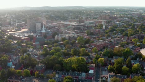 view from airplane window flying over american city at sunrise, sunset