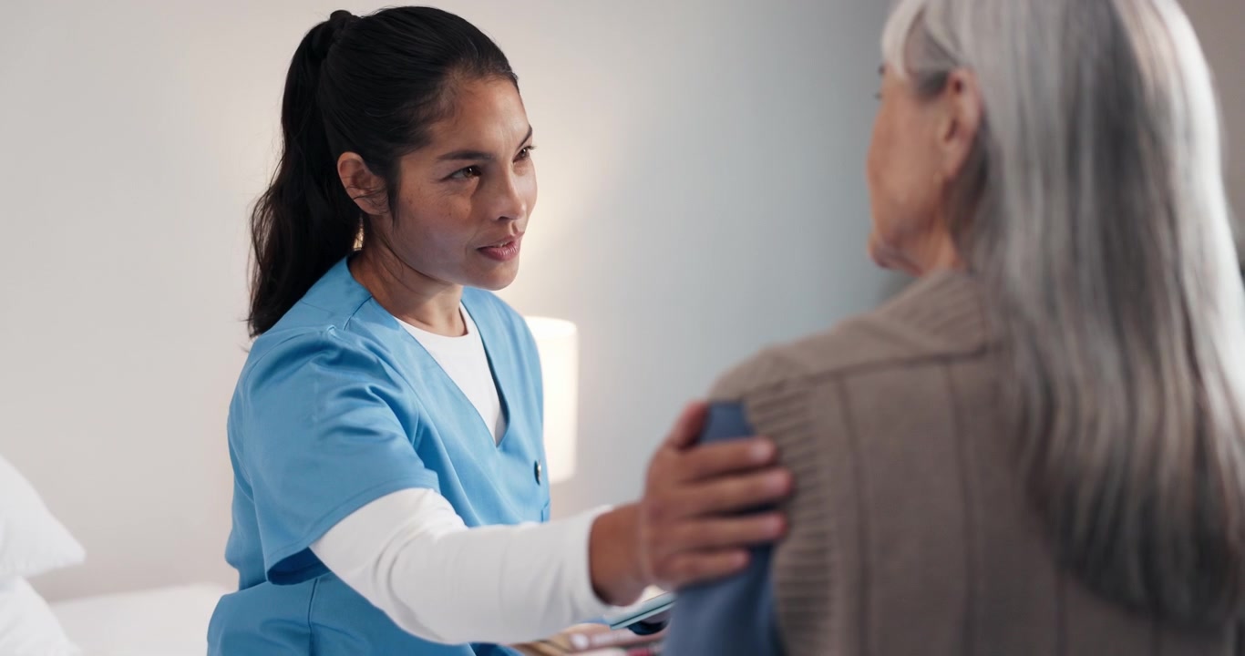 Compassionate Nurse Comforting Senior Patient During Consultation