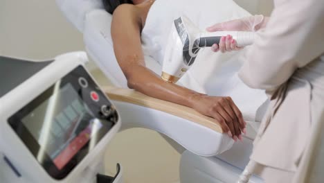 laser epilation and cosmetology in beauty salon. hair removal procedure. laser epilation, cosmetology, spa, and hair removal concept. beautiful woman getting hair removing on legs