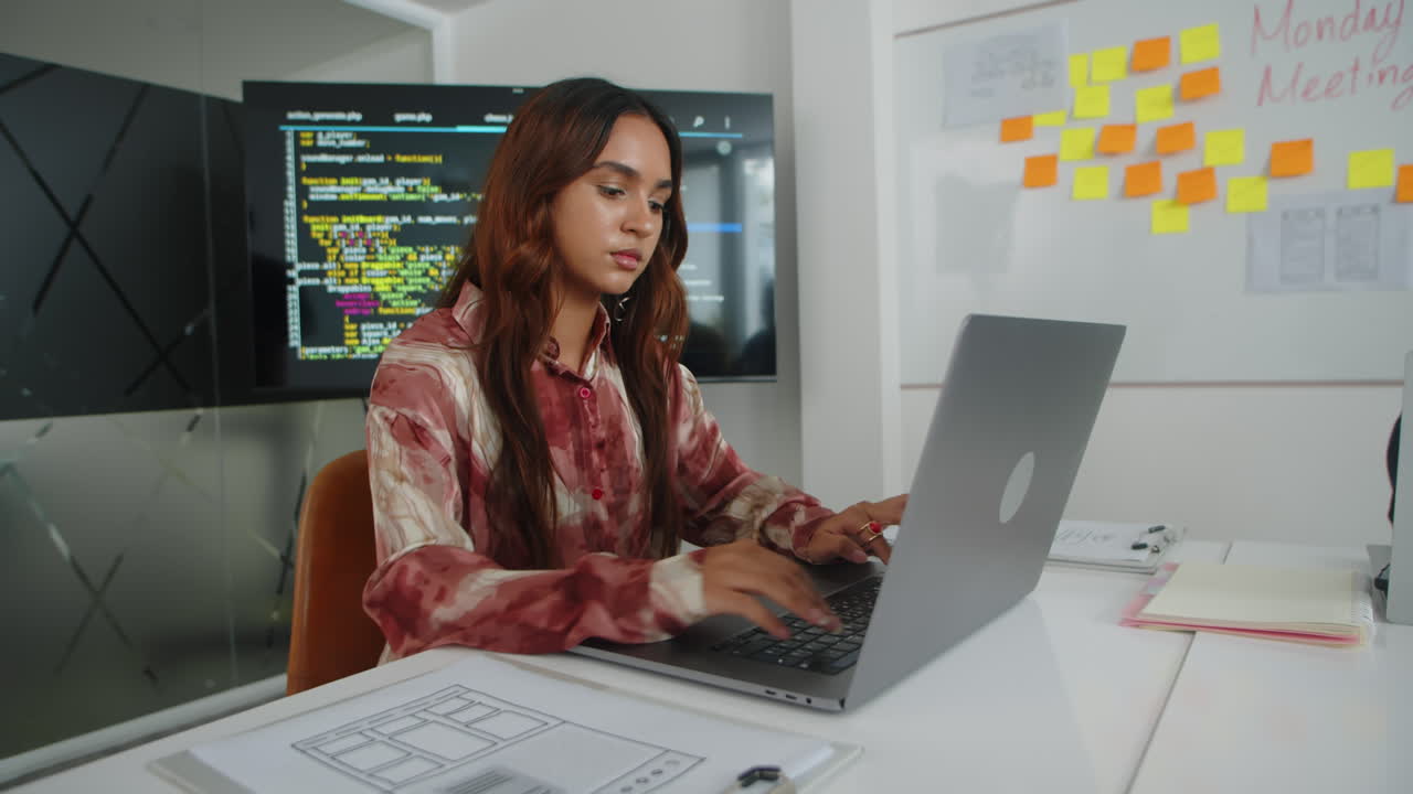 Female Developer Working on Laptop in Office