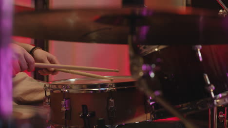 unrecognizable man playing drums in recording studio 1