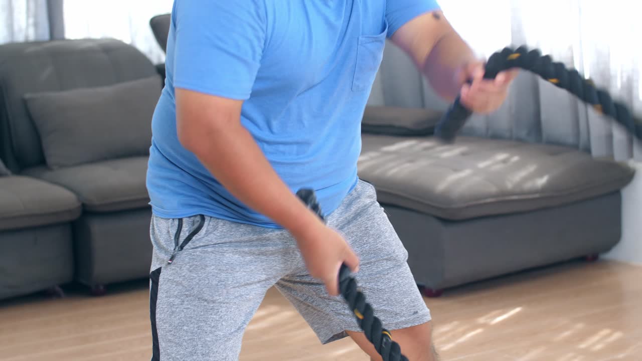 Man exercising with resistance band at home