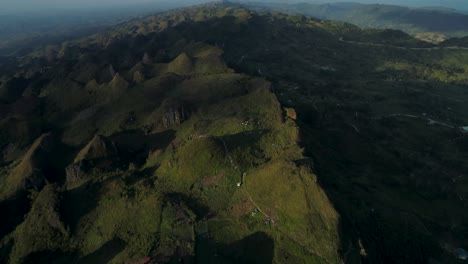 scenic sunlight shines on mountain range slope of cebu island, aerial