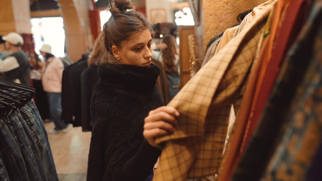 Woman Shopping for Vintage Clothing in a Secondhand Store