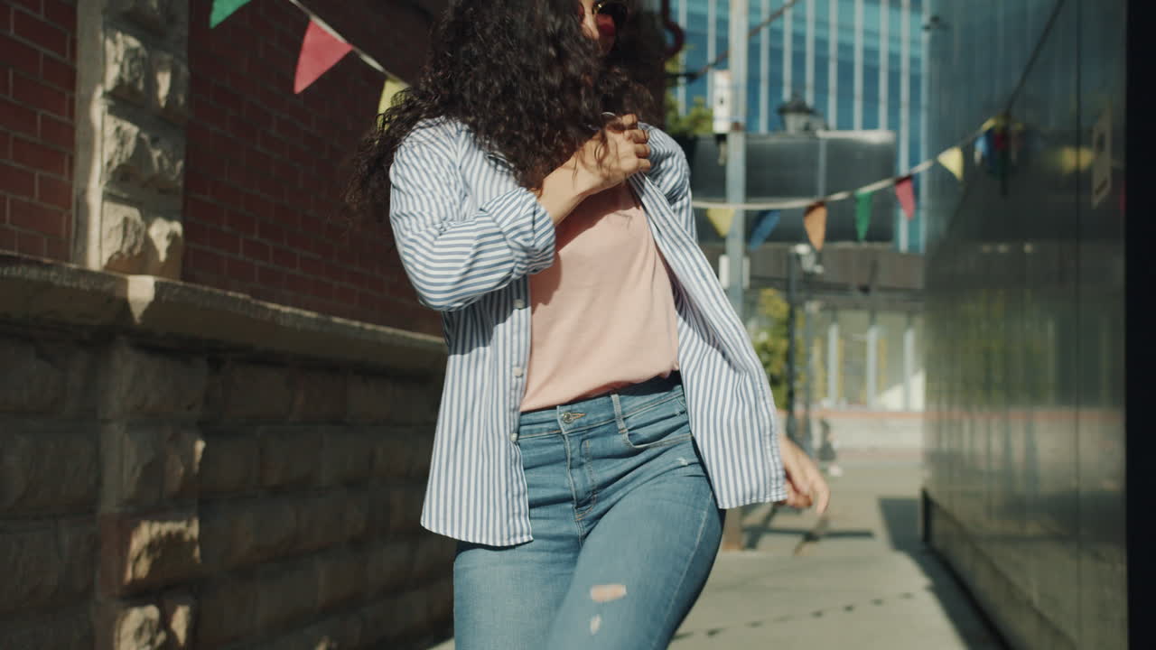 Joyful Woman Dancing in a City Alley