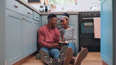 phone, floor and couple in kitchen